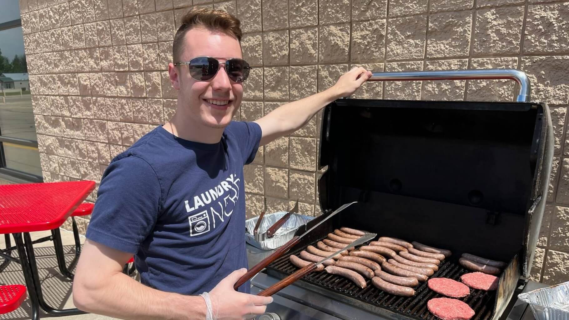Alliance employee grilling brats at Laundry Nerd event