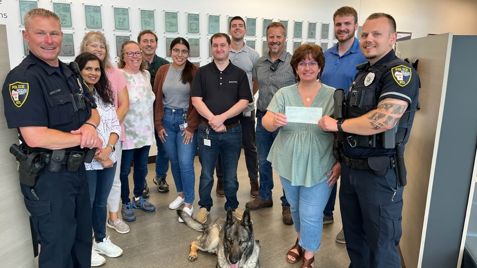 Alliance Laundry Systems employees posing with local police department